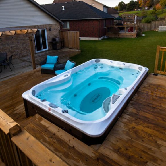 Jcz20 12ft Jacuzzi Swim Spa Install Orangeville No Cover Image2 405x720 E8e8763e 2dc1 4dc6 88f8 Cc60053a4b23 Swim spa in garden with decking