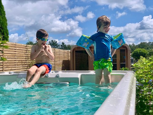 Kids Playing In Hydrolife Swimspa 1 Swim spa in garden with decking